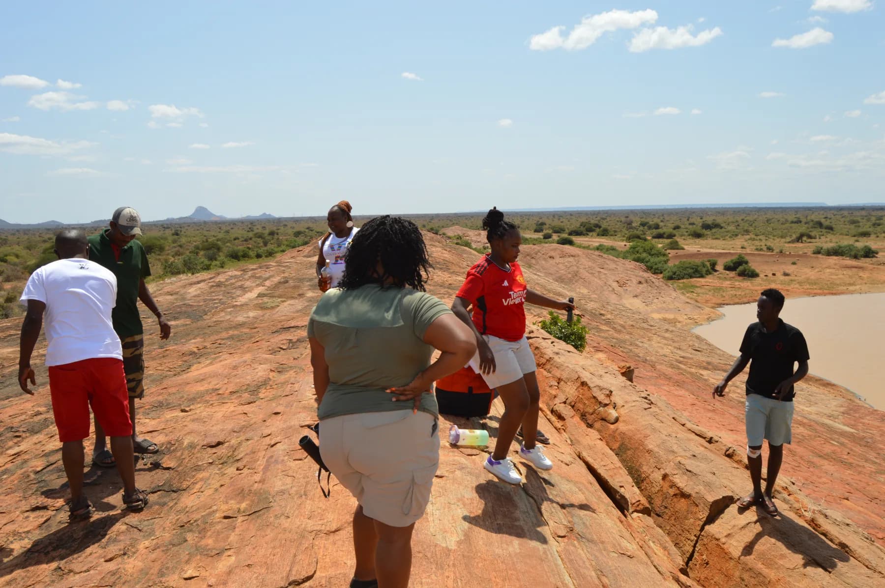 A group walking across the top of Mudanda Rock in Tsavo East