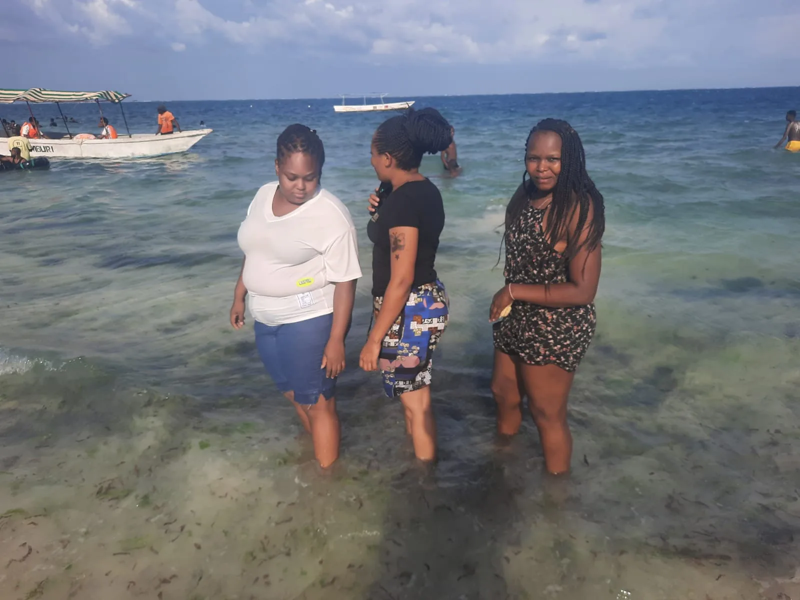 Travellers wading in the sea at Nyali Beach